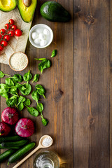 Fresh organic vegetables on dark wooden background top view copy space. Kitchen desk for preparing salad