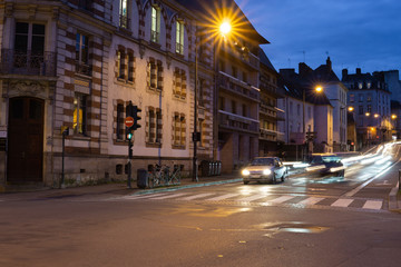 Long exposure night shot cars driving French street