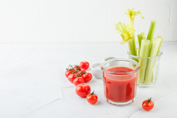 Glass of tomato juice and celery stems