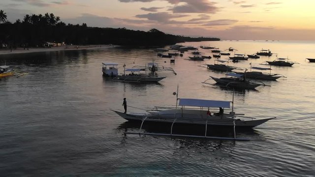 Philippines Beach Resort, Bangka Boats Sailing at Sunrise.