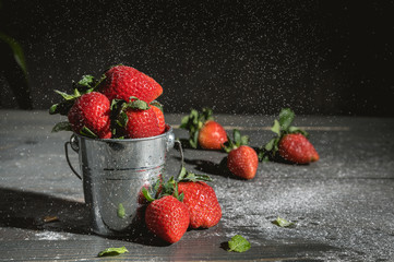 Sugar pouring over strawberries