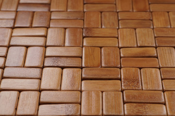  Background. The mat is made of rectangular, sanded and varnished bamboo wood blocks.