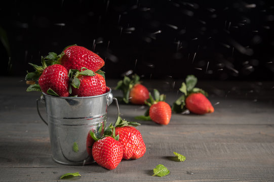 Sugar pouring over strawberries