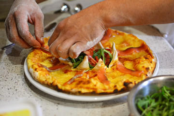 Chef baker hands cooking pizza