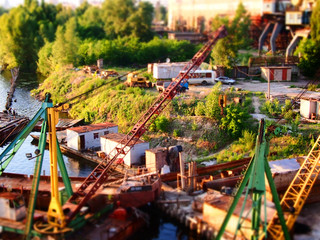 Art photo with a bright industrial background. Port on the river. Soft focus and bright colors.