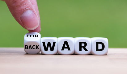 Hand turns a dice and changes the word "BACKWARD" to "FORWARD".