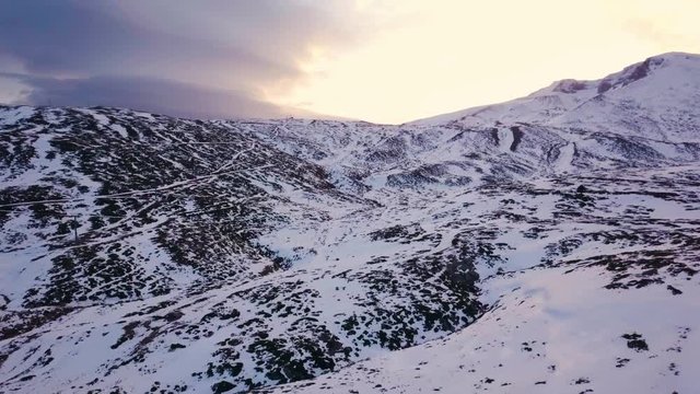 drone dolly forward, in slowmotion, over mystic and deserted snowy mountain, in Turkey