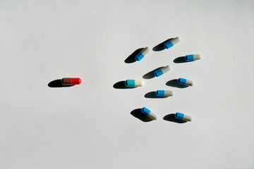 The concept of drug treatment of infertility. Tablets, pills, capsules depict sperm and egg. Fertilization process. Shooting in hard daylight.