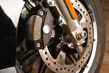 Obraz premium front fork of a motorcycle with a front wheel, brake disc, brake cylinder. Close up. Soft focus