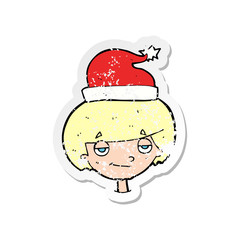 retro distressed sticker of a cartoon boy in santa hat