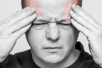 Terrible headache. Man having a headache. Young man suffering from headache. Man hold his had and suffering from headache, pain, migraine, sad depressed
