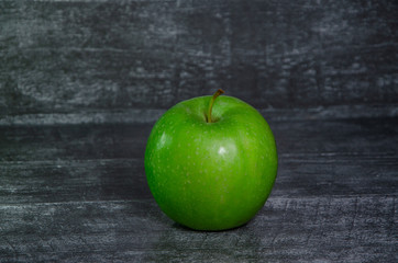 green apple on wooden table