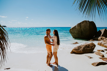 honeymoon couple relax on beach in tropics