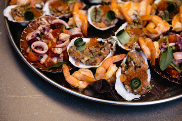 Assorted seafood, mussels, squid, scallops, salmon fillet and tiger shrimps with garlic creamy sauce, parmesan cheese and basil