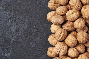 Walnut on black table, with copy space. Organic nuts.Top view.