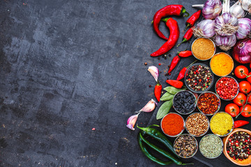Big set of Indian spices and herbs . On the black chalkboard.