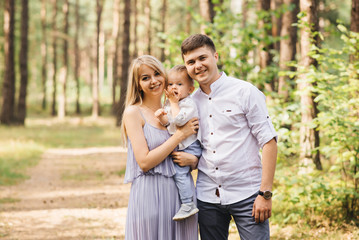 Happy young family spends time together in nature.