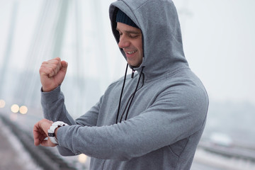 a middle-aged man taking pulse during the training outdoor