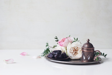 Ramadan Kareem greeting card, invitation. Plate with dates fruit, bronze coffee cup, pink roses and...