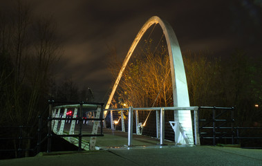 whitehall bridge a pedestrian footbridge crossing the river aire in leeds illuminated at night
