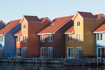 Famous Dutch cityscape, Reitdiephaven street with traditional colorful houses on water, Groningen, Netherlands, This buildings inspired by Scandinavian homes