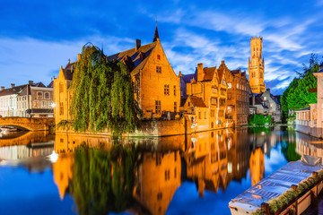 Fototapeta na wymiar Bruges, Belgium. The Rozenhoedkaai canal in Bruges with the Belfry in the background.