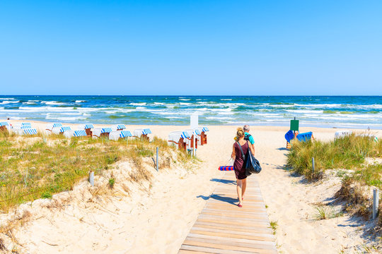 Unidentified couple of people walking to beach in Baabe village, Ruegen island, Baltic Sea, Germany.