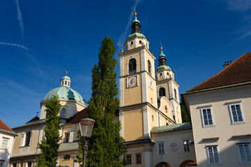 Obraz premium Clock and Bell towers with copper dome of St. Nicholas Catholic church Ljubljana Cathedral from Pogacar Square Ljubljana Slovenia