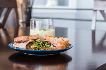 ham sandwich and broccoli soup on dining table