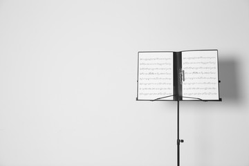 Note stand with music sheets on white background. Space for text