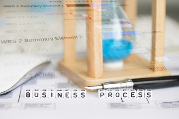 Business process conceptual image with hourglass and abstract graphs on background