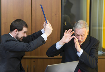 Angry employee attacking his boss