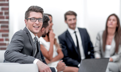 Fototapeta na wymiar smiling businessman in the workplace