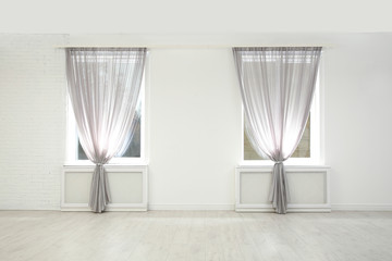 Modern windows with curtains in room. Home interior