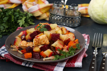 Baked chicken with vegetables: beets, carrots, cabbage and potatoes