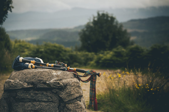 isolated bagpipes in scotland highlands laying on a rock in middle of summer great illustration of scottish culture