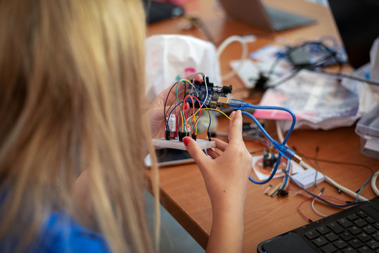 young girl building a computer controlled device