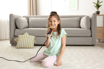 Cute funny girl with microphone in living room