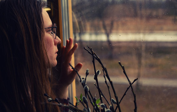 Sad Woman Looking Through Rainy Window