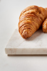 Croissants on the white marble board