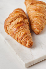 Croissants on the white marble board