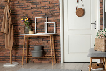 Hallway interior with stylish table and bench