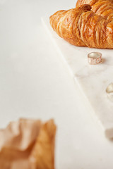 Croissants, and rings on the white marble board
