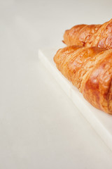 Croissants on the white marble board