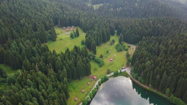hd aerial spinning shot, slow motion, over gigantic forest, near lake, in Savsat Karagol Artvin Turkey