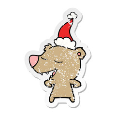 distressed sticker cartoon of a bear wearing santa hat