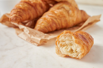 Croissants on the parchment paper, on the marbel board