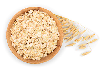 oat spike with oat flakes in wooden bowl isolated on white background. Top view. Flat lay