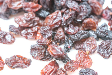 Raisins heap isolated on white background