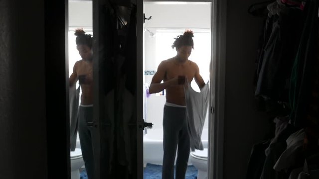 African American man getting dressed to start his day.